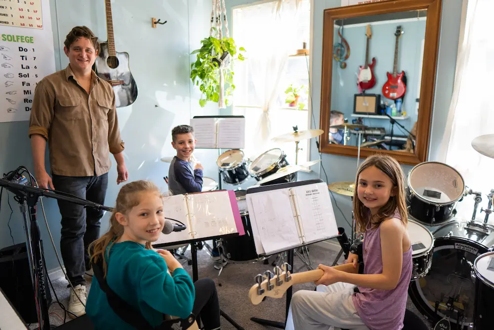 Music students practicing together in a band rehearsal space