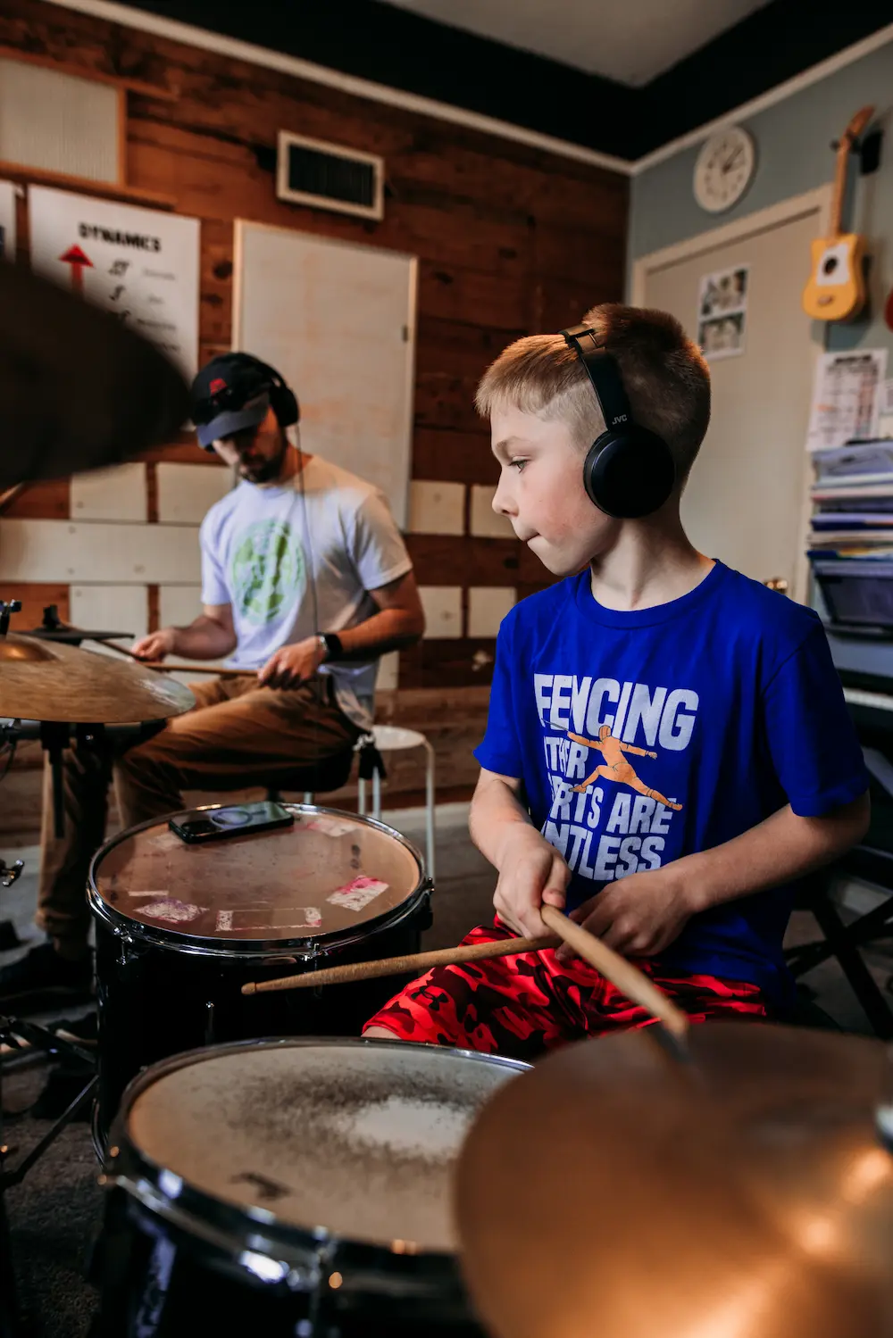 Two students practicing drums together