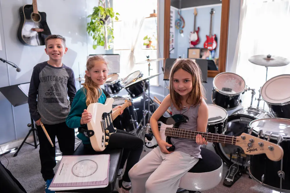 Three students rehearsing together as a band