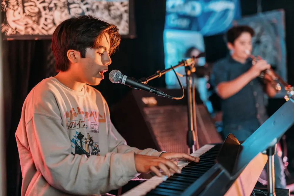 student playing piano and singing