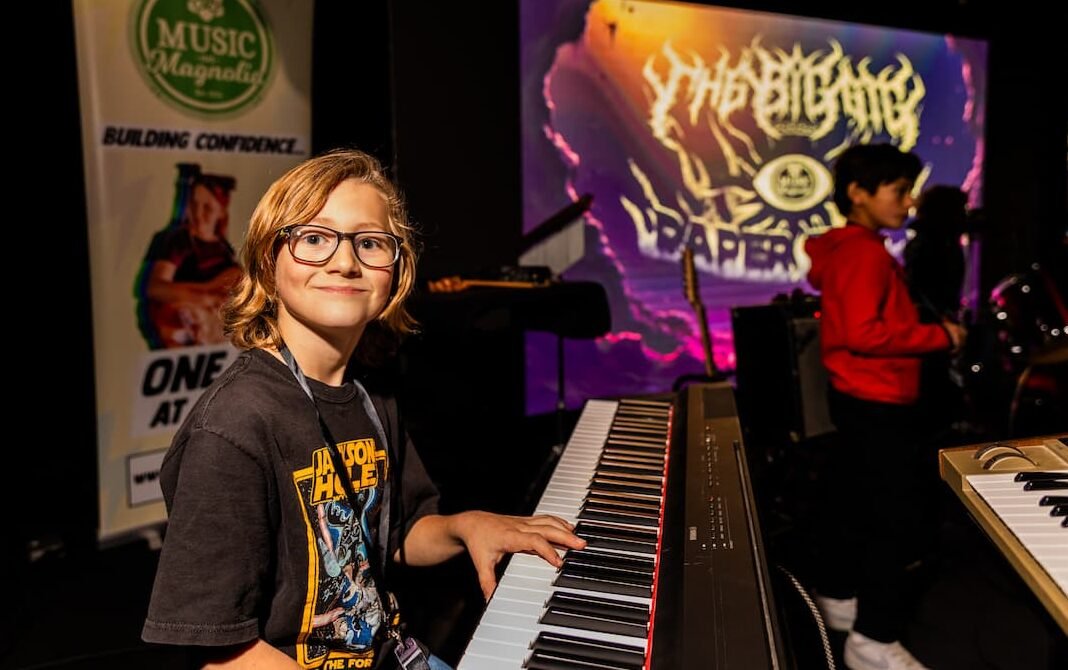 boy playing piano on stage