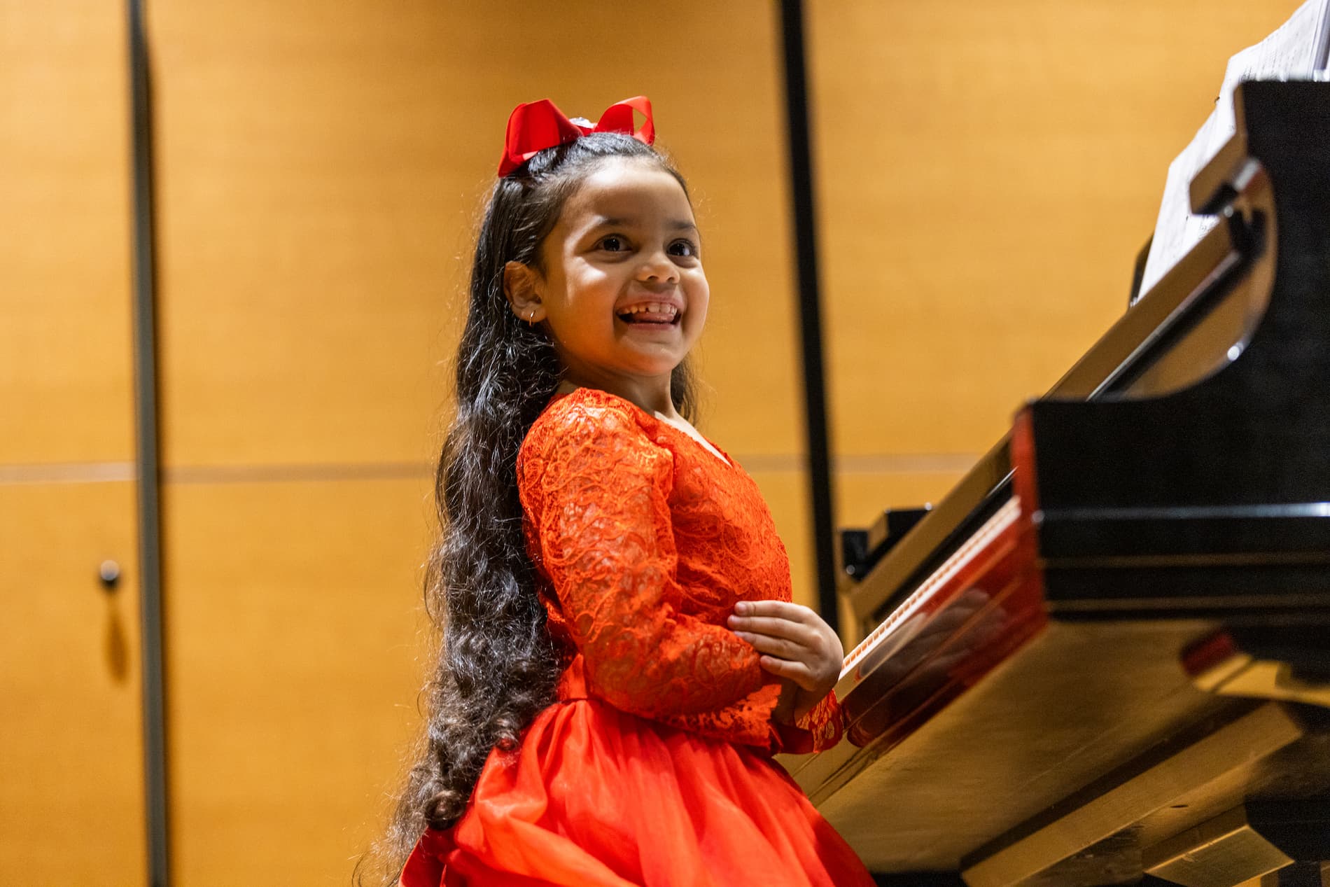 happy piano student at a performance