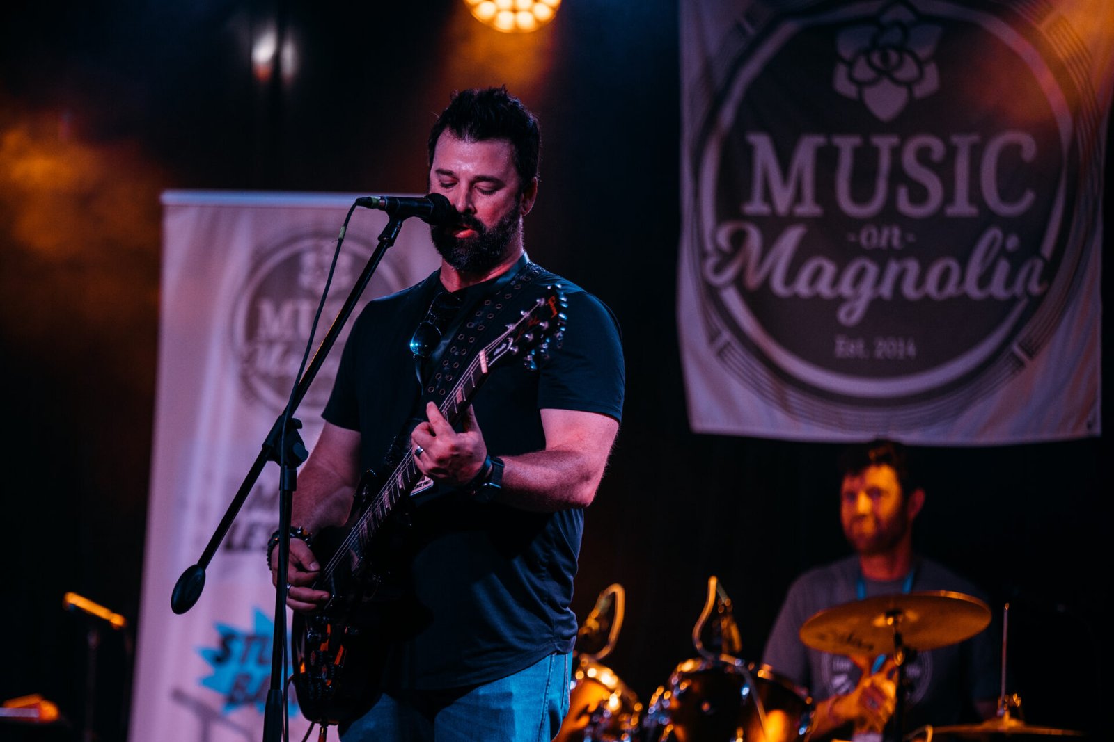 singer on stage with guitar
