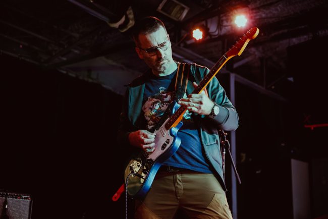 Adult Playing Guitar