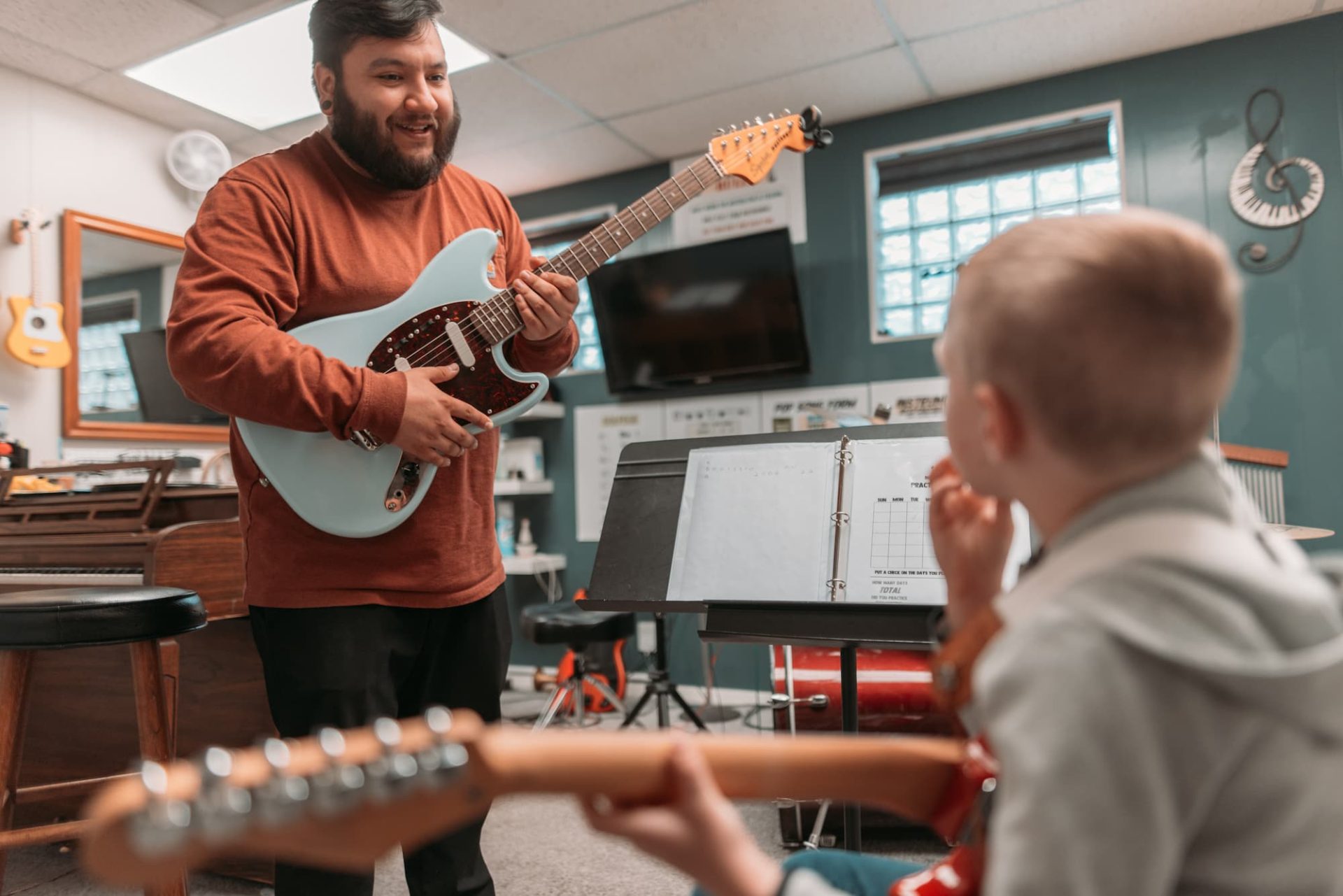 Student and Teacher in Guitar Lessons
