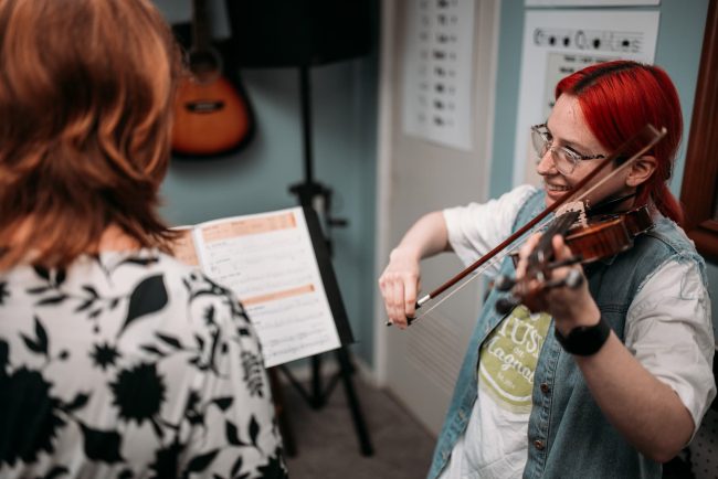 Teacher and Student Playing Violin