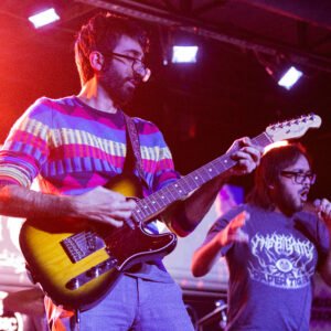 adult guitar student performing live at music lesson program in San Antonio